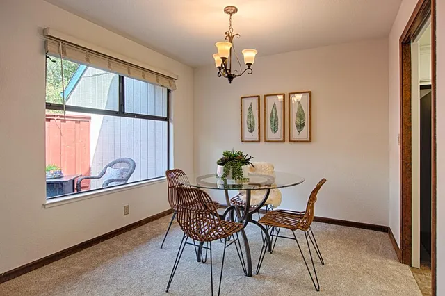 a dining room with furniture and window