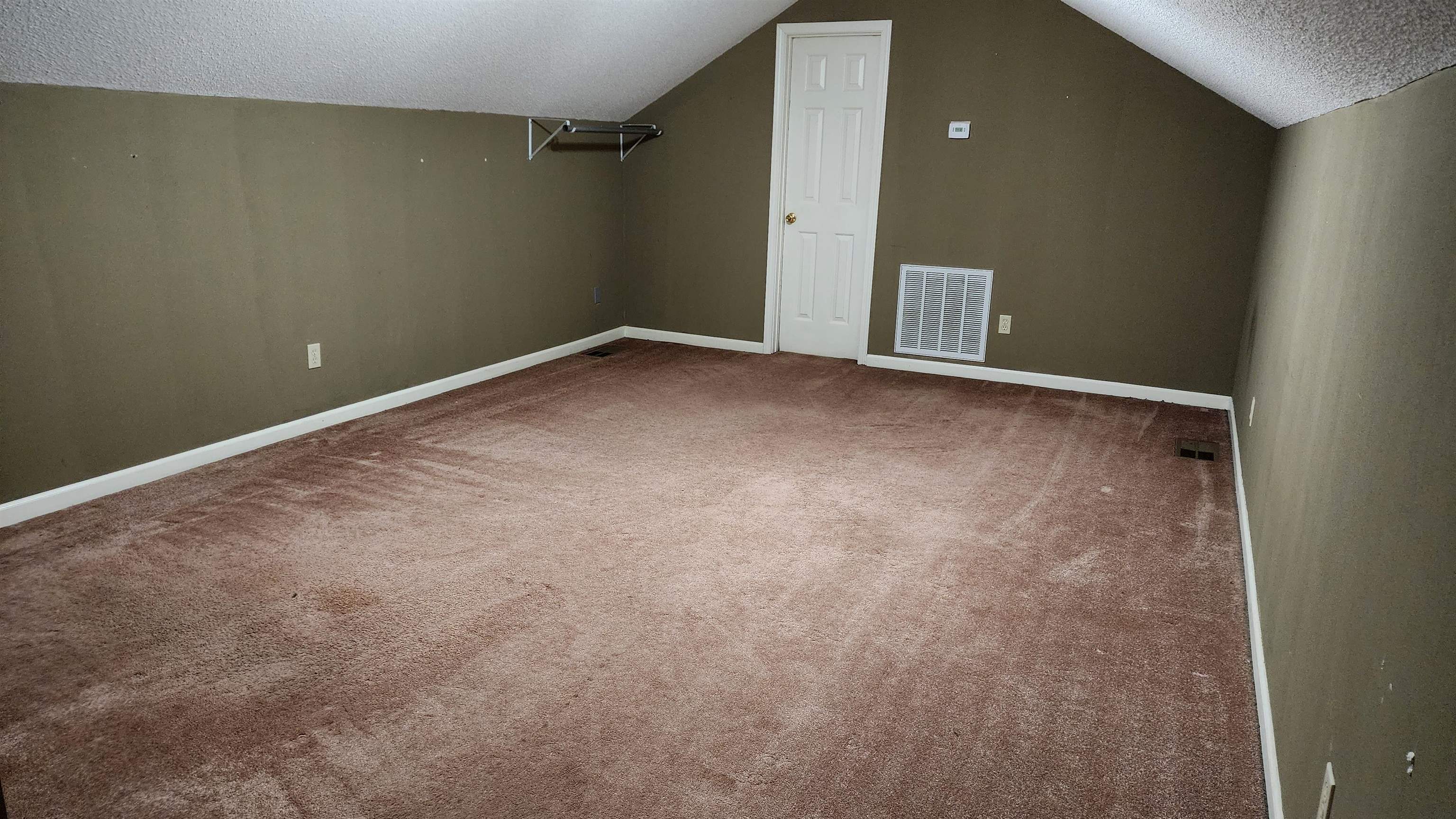 445 Caldwell Road Ripley, TN 38063 - Photo 12 of 14 Additional living space with a textured ceiling, lofted ceiling, carpet flooring, and baseboards