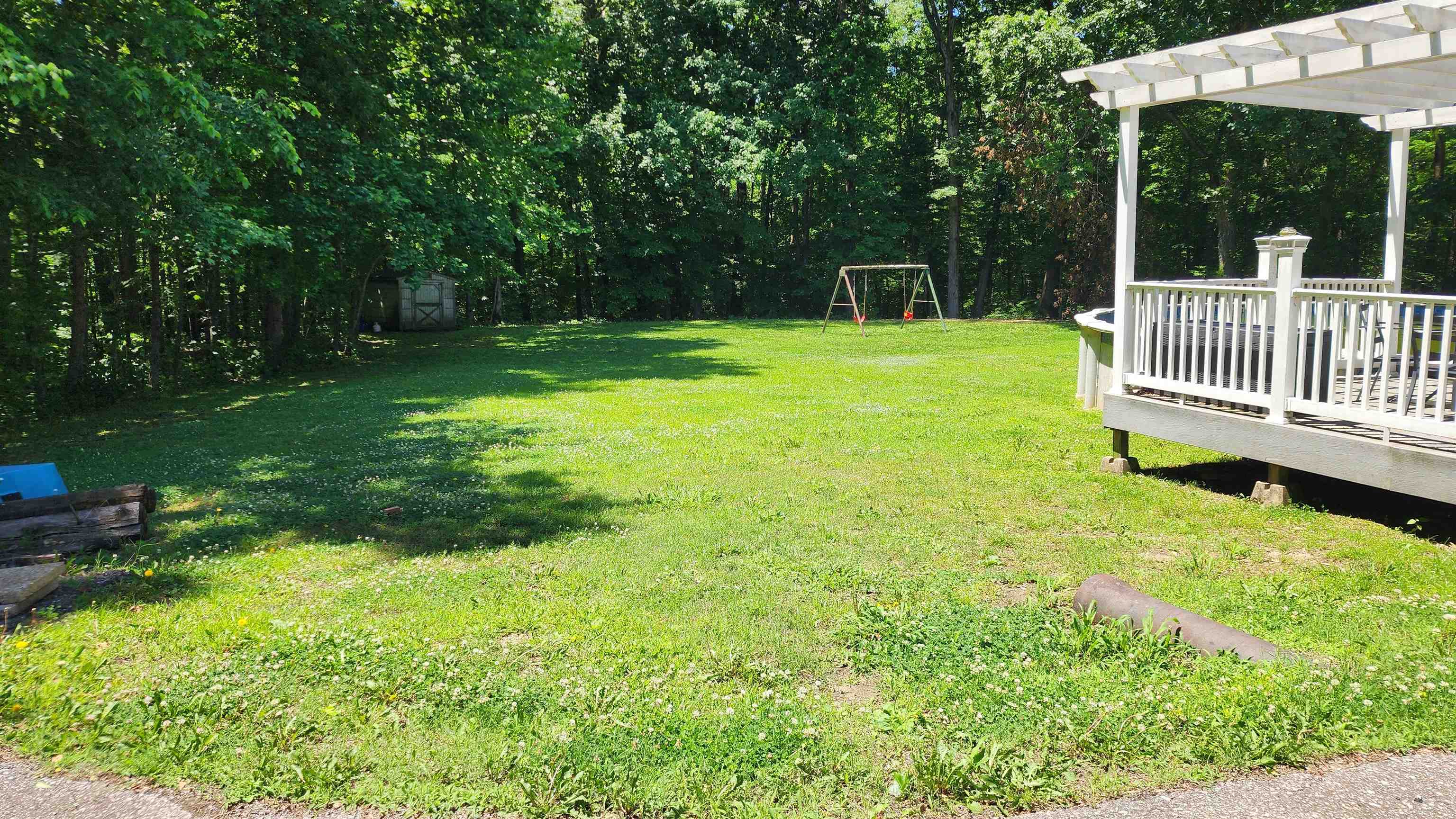 445 Caldwell Road Ripley, TN 38063 - Photo 14 of 14 View of grassy yard featuring a wooden deck and a pergola