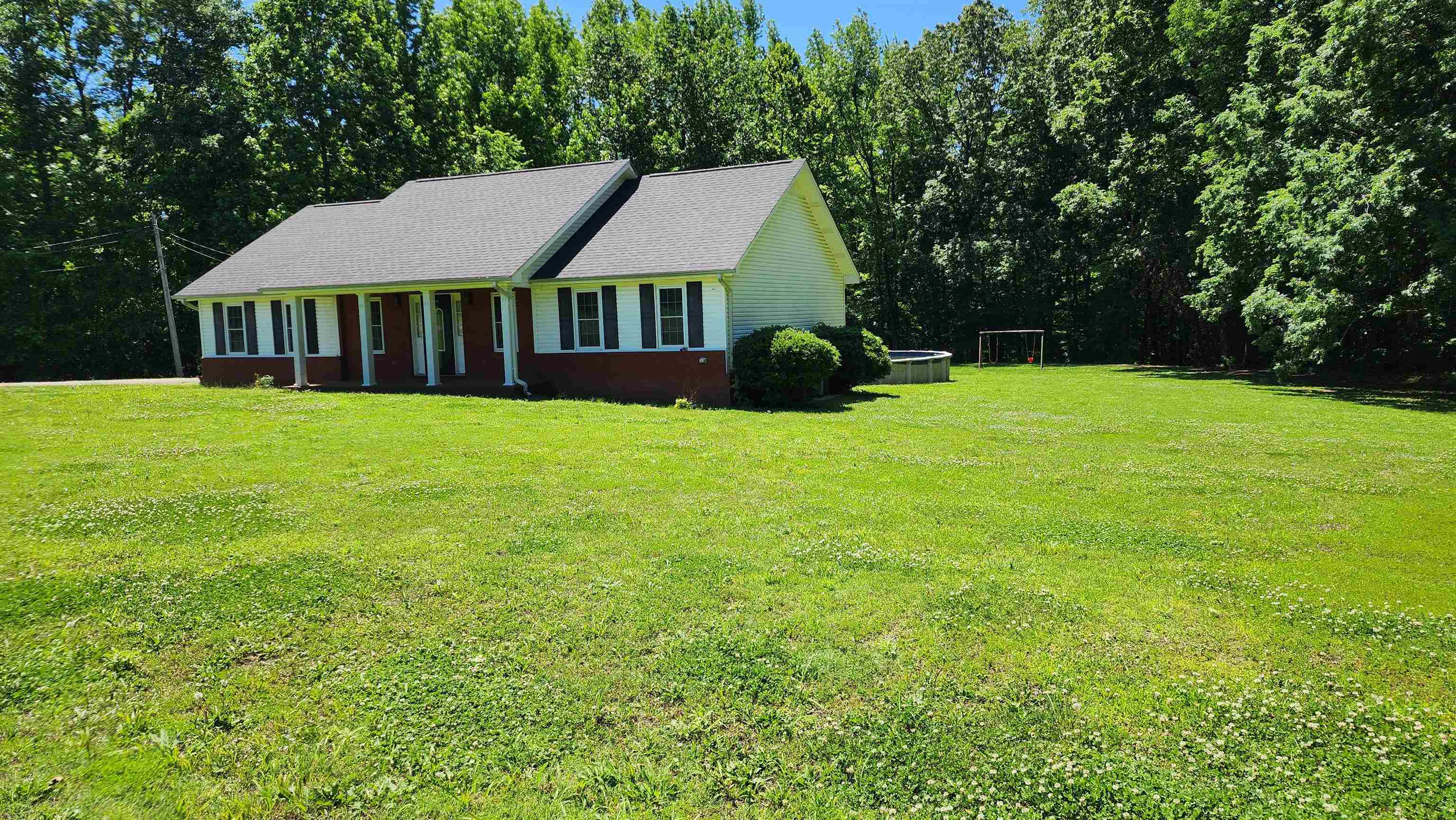 445 Caldwell Road Ripley, TN 38063 - Photo 2 of 14 View of front facade with a front lawn