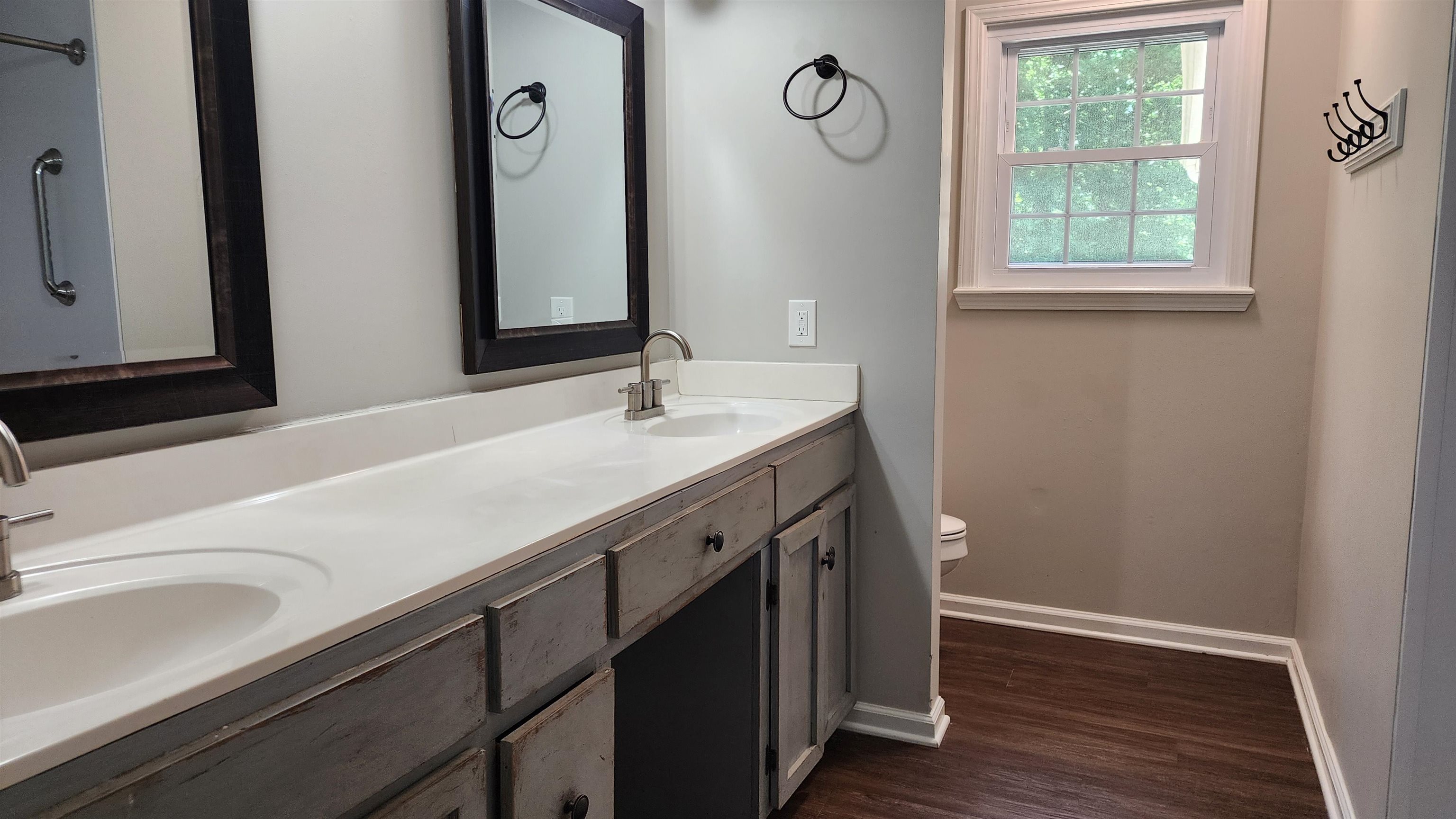 445 Caldwell Road Ripley, TN 38063 - Photo 7 of 14 Bathroom with toilet, wood finished floors, double vanity, and baseboards