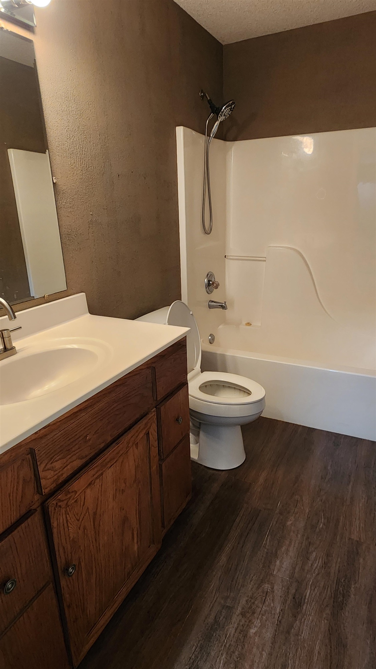 445 Caldwell Road Ripley, TN 38063 - Photo 9 of 14 Full bathroom featuring wood finished floors, vanity, toilet, shower / bath combination, and a textured ceiling