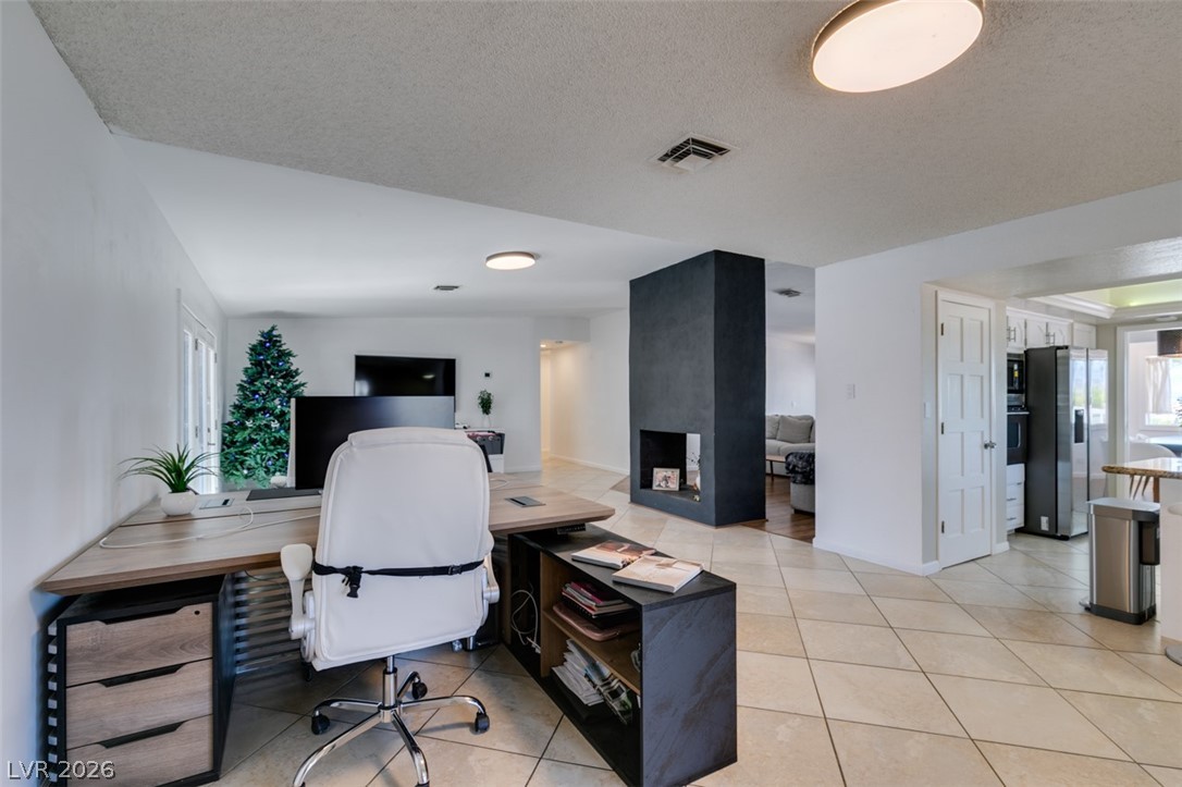 892 North Hollywood Boulevard Las Vegas, NV 89110 - Photo 28 of 81 This versatile space features a dedicated office area, seamlessly connecting to an open living area and kitchen.