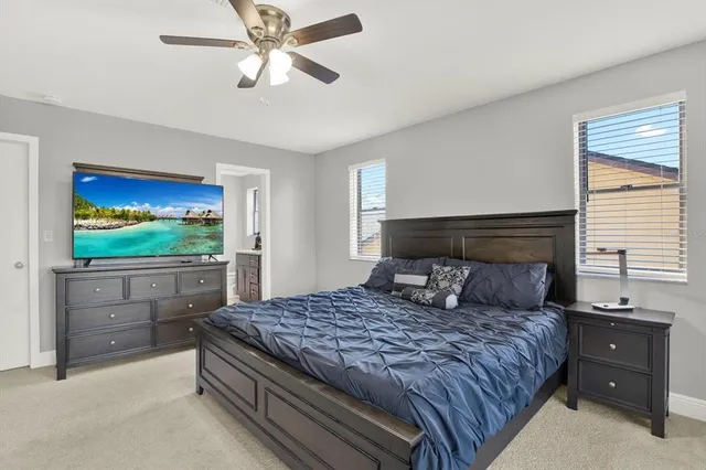 a bedroom with a large bed and a window