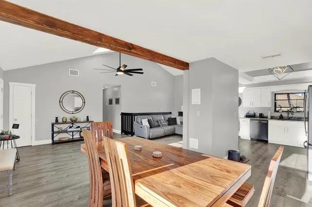 a living room with furniture a clock and wooden floor