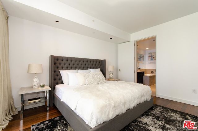 a large bed sitting in a bedroom next to a window