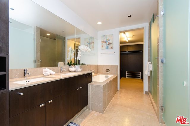 a spacious bathroom with a sink a mirror and a bathtub