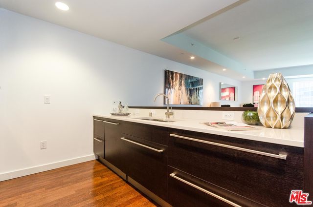 a room with stainless steel appliances sink and cabinets