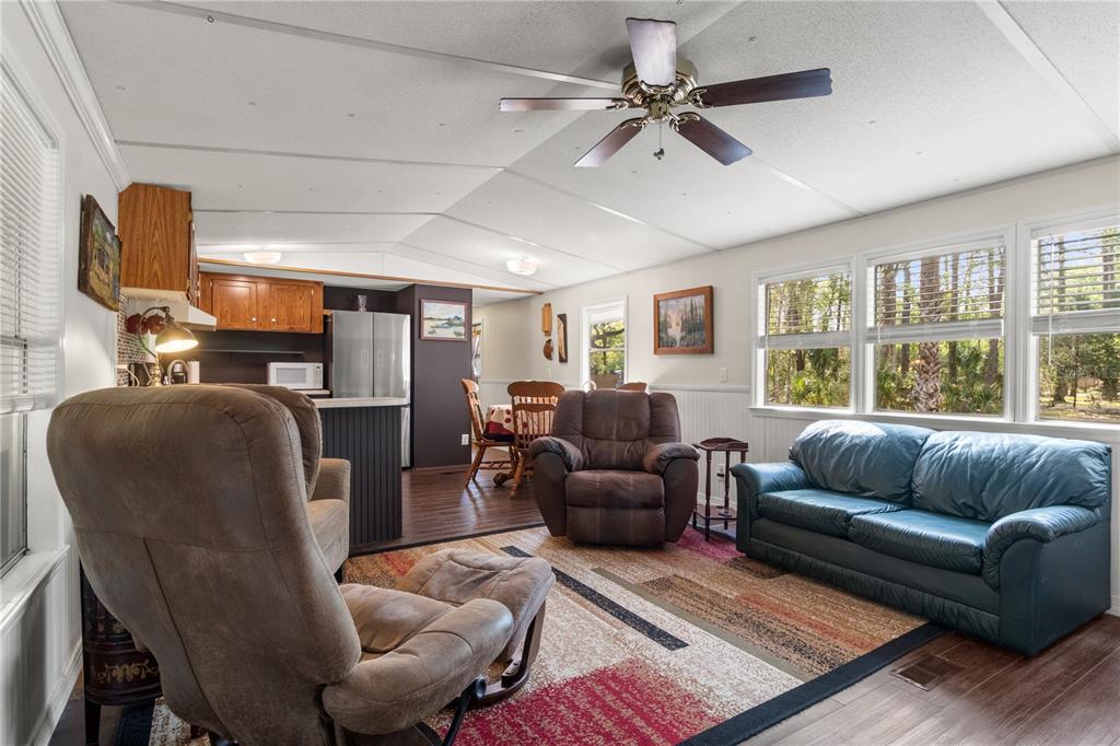 3650 176 Place Inglis, FL 34449 - Photo 15 of 49 a living room with furniture ceiling fan and a window