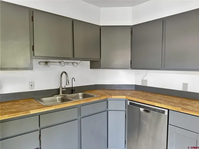 a kitchen with a sink and cabinets