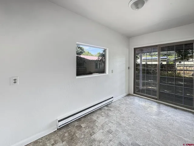 a view of an empty room with glass door