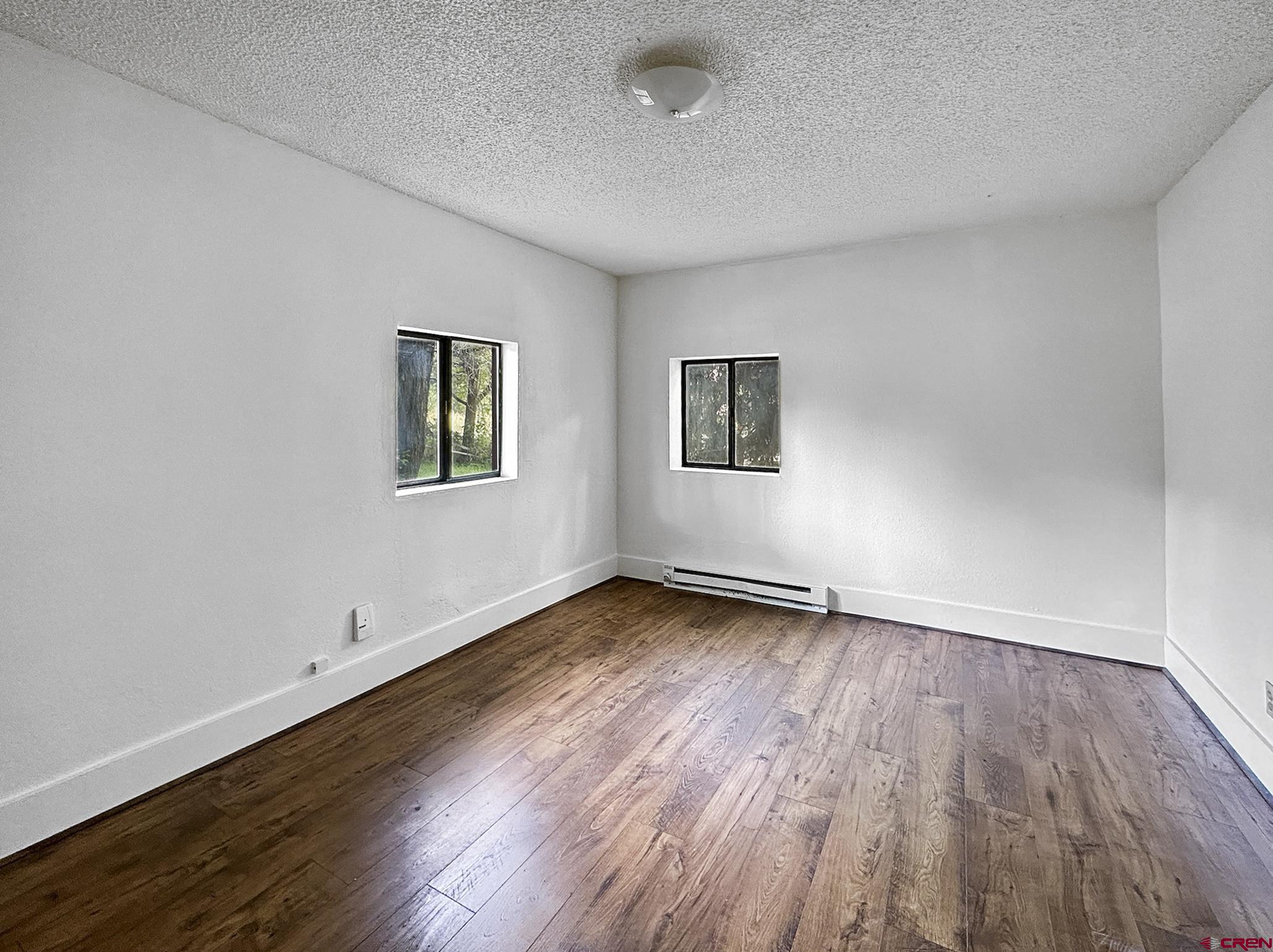 438 Stahl Road Paonia, CO 81428 - Photo 21 of 33 a view of an empty room with wooden floor and a window