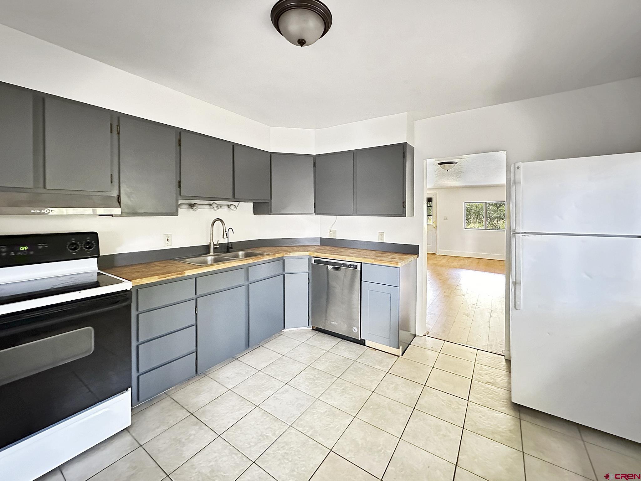 438 Stahl Road Paonia, CO 81428 - Photo 22 of 33 a kitchen with a sink a stove a refrigerator and cabinets