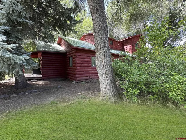 a view of a house with a tree