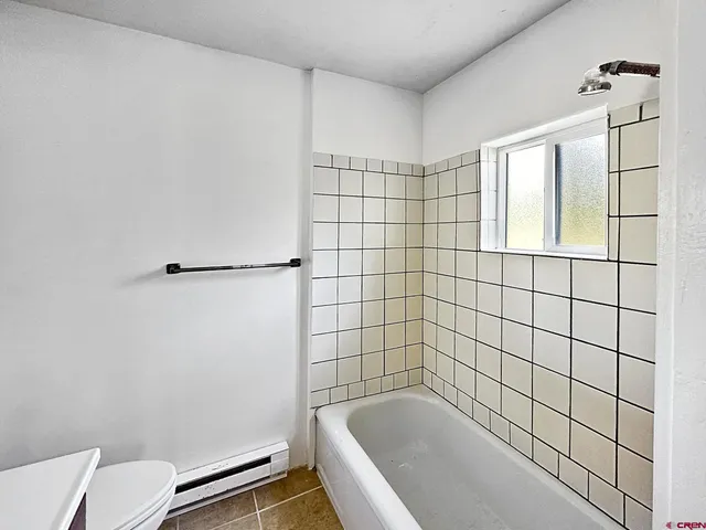 a bathroom with a bathtub and shower