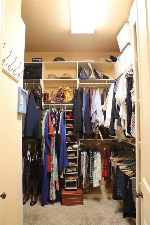 5614 Pleasant Ridge Road Dallas, TX 75236 - Photo 11 of 23 a view of walk in closet with clothes and shoes