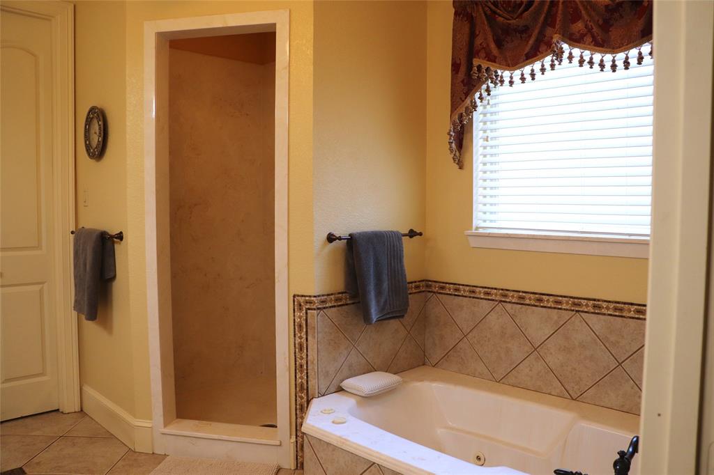 5614 Pleasant Ridge Road Dallas, TX 75236 - Photo 12 of 23 a bathroom with a bathtub and shower