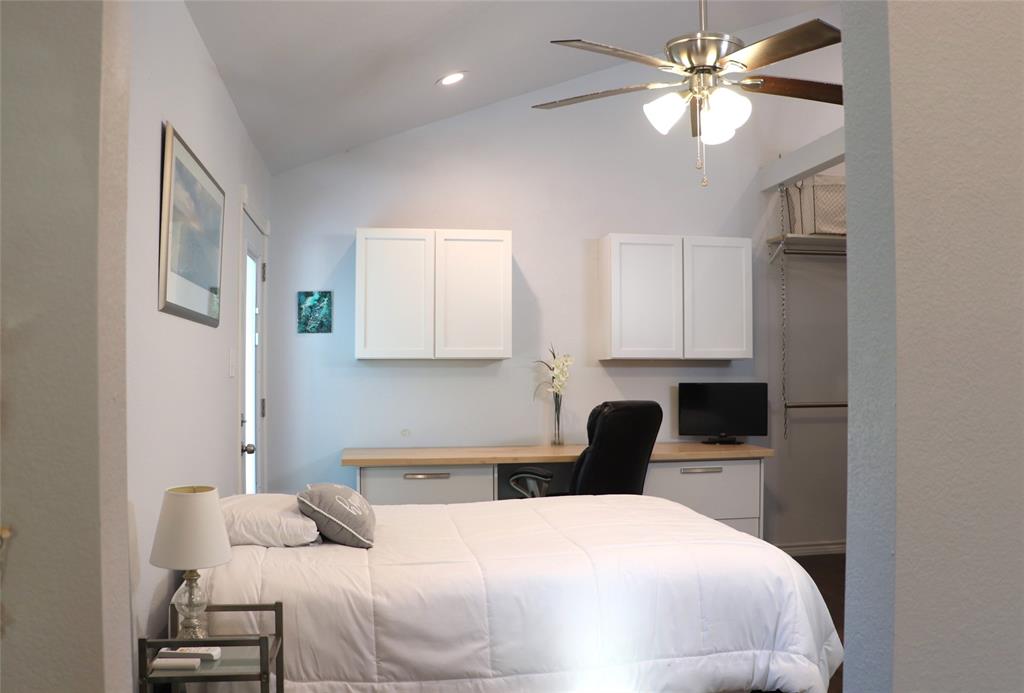 5614 Pleasant Ridge Road Dallas, TX 75236 - Photo 22 of 23 a bedroom with a bed and a chandelier