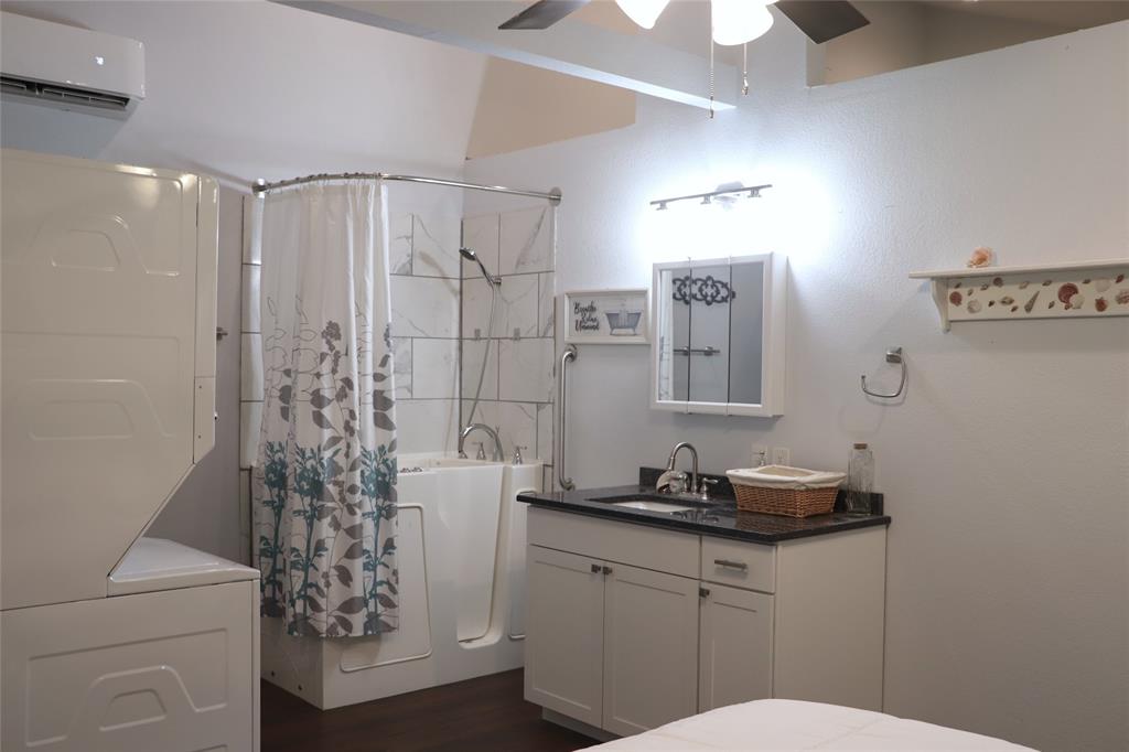 5614 Pleasant Ridge Road Dallas, TX 75236 - Photo 23 of 23 a bathroom with a granite countertop sink a toilet a shower and a mirror