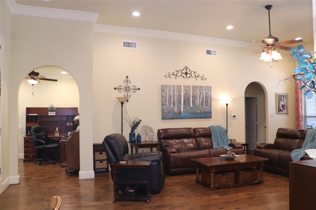 5614 Pleasant Ridge Road Dallas, TX 75236 - Photo 3 of 23 a living room with furniture a fireplace and a chandelier