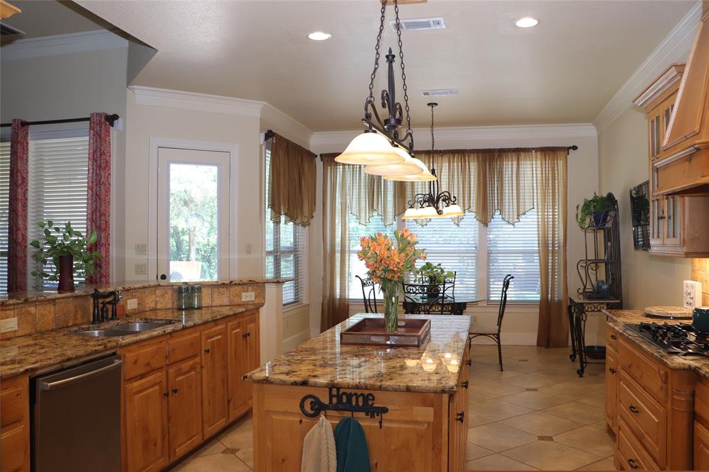 5614 Pleasant Ridge Road Dallas, TX 75236 - Photo 6 of 23 a kitchen with stainless steel appliances granite countertop a stove a sink and a refrigerator