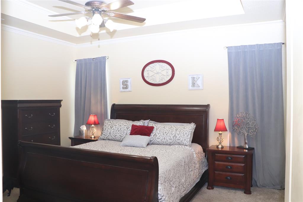 5614 Pleasant Ridge Road Dallas, TX 75236 - Photo 9 of 23 a bedroom with a bed and a chandelier