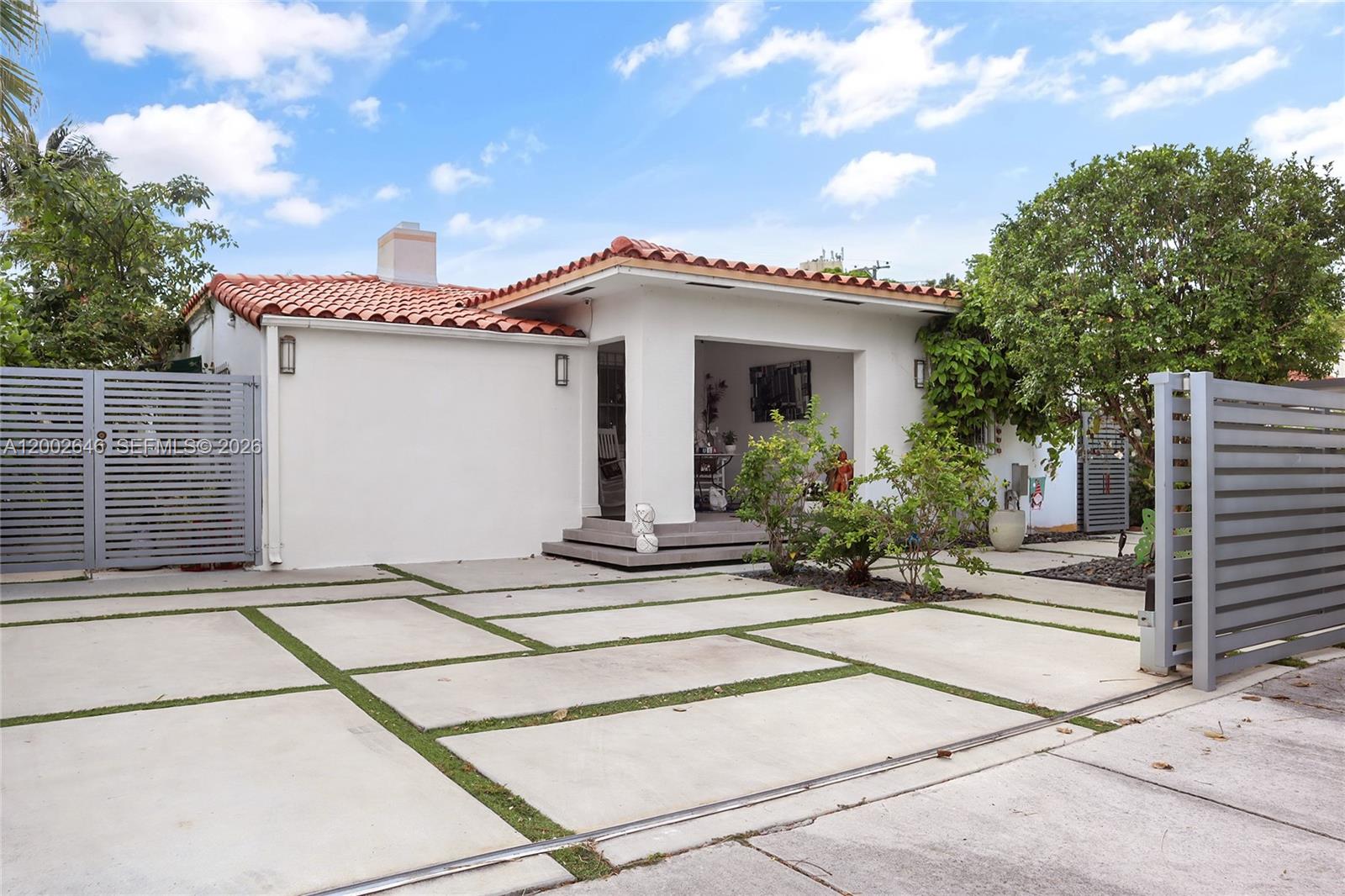 a front view of a house with a garden