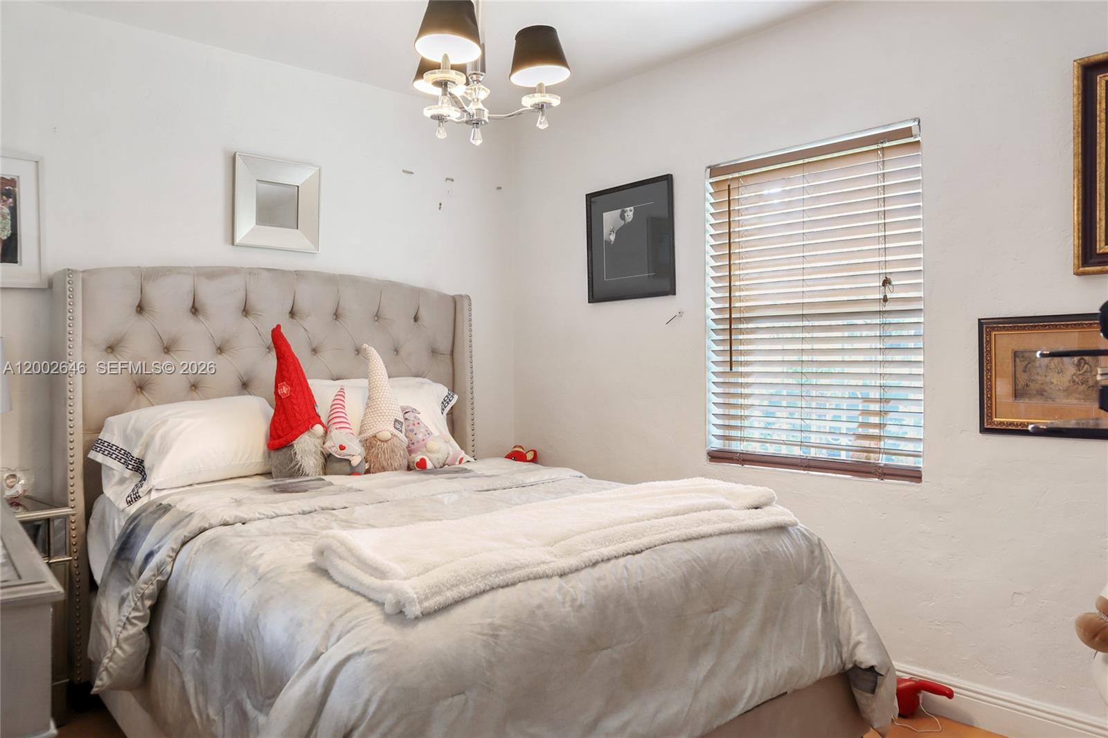 619 Southwest 39th Avenue Miami, FL 33134 - Photo 12 of 24 a bedroom with a bed and a chandelier