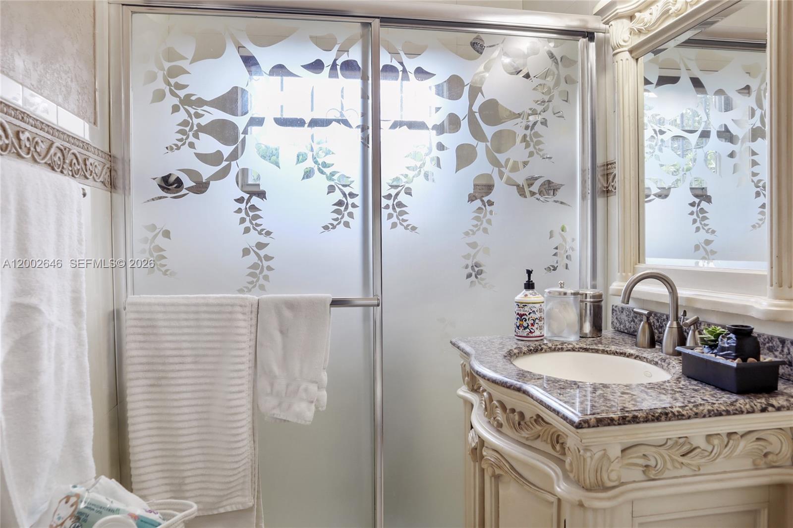 619 Southwest 39th Avenue Miami, FL 33134 - Photo 14 of 24 a bathroom with a granite countertop shower sink and vanity