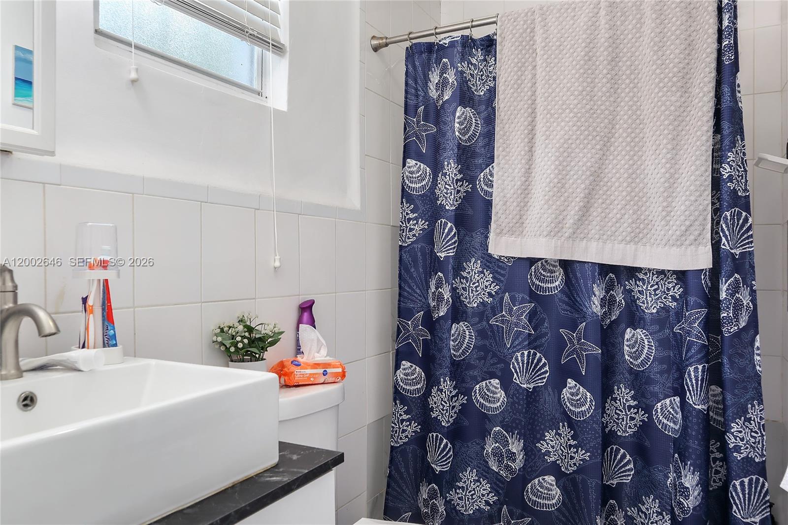 619 Southwest 39th Avenue Miami, FL 33134 - Photo 20 of 24 a bathroom with a sink and a shower curtain