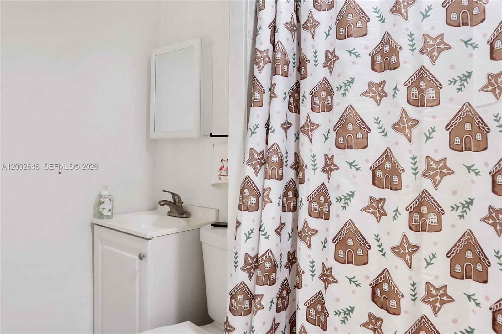 619 Southwest 39th Avenue Miami, FL 33134 - Photo 24 of 24 a bathroom with a sink and mirror with toilet