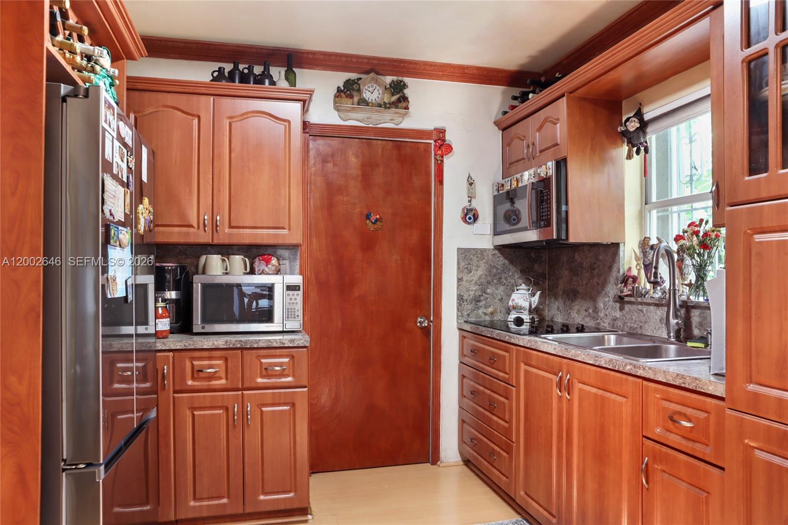 619 Southwest 39th Avenue Miami, FL 33134 - Photo 5 of 24 a kitchen with stainless steel appliances granite countertop a refrigerator and a sink