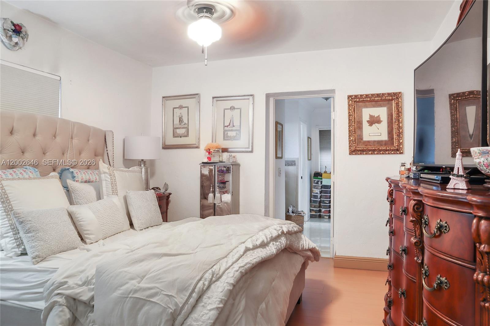 619 Southwest 39th Avenue Miami, FL 33134 - Photo 8 of 24 a bedroom with a bed and a chandelier