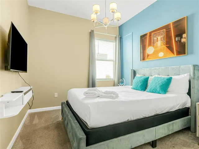 a bedroom with a bed and a flat screen tv