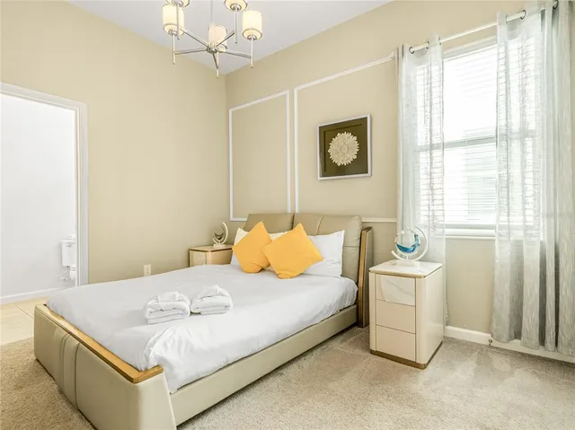 a bedroom with a bed and window