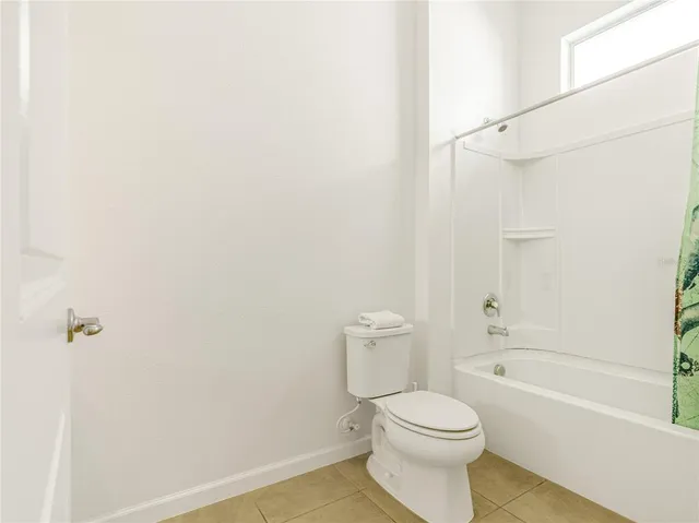 a bathroom with a toilet and a bathtub