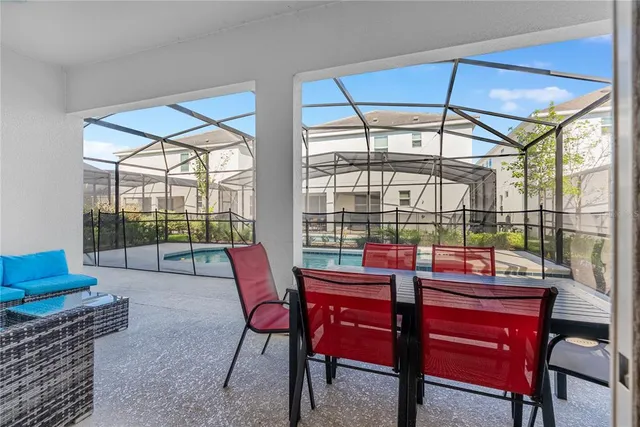 a dining room with furniture and a floor to ceiling window