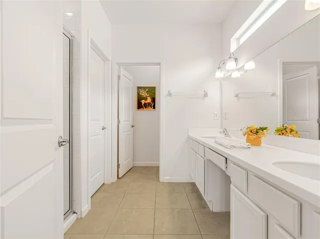 a bedroom with a bed and painting on the wall