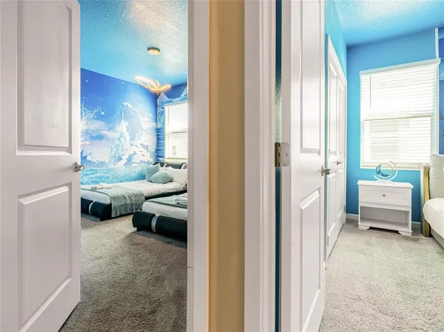 a bedroom with a bed and a chandelier