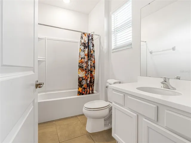 an aerial view of a house with garden space and swimming pool