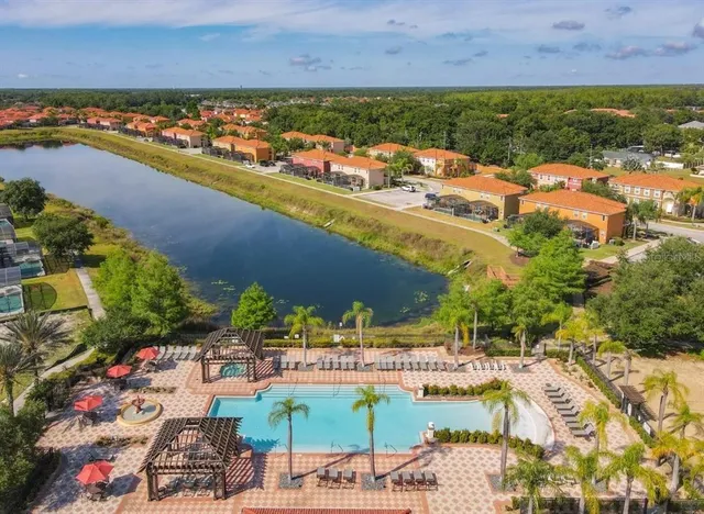 an aerial view of a house with yard swimming pool and outdoor seating