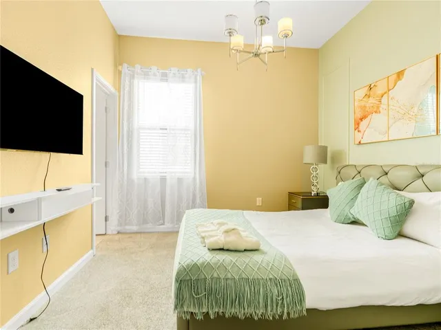a bedroom with a bed and flat screen tv