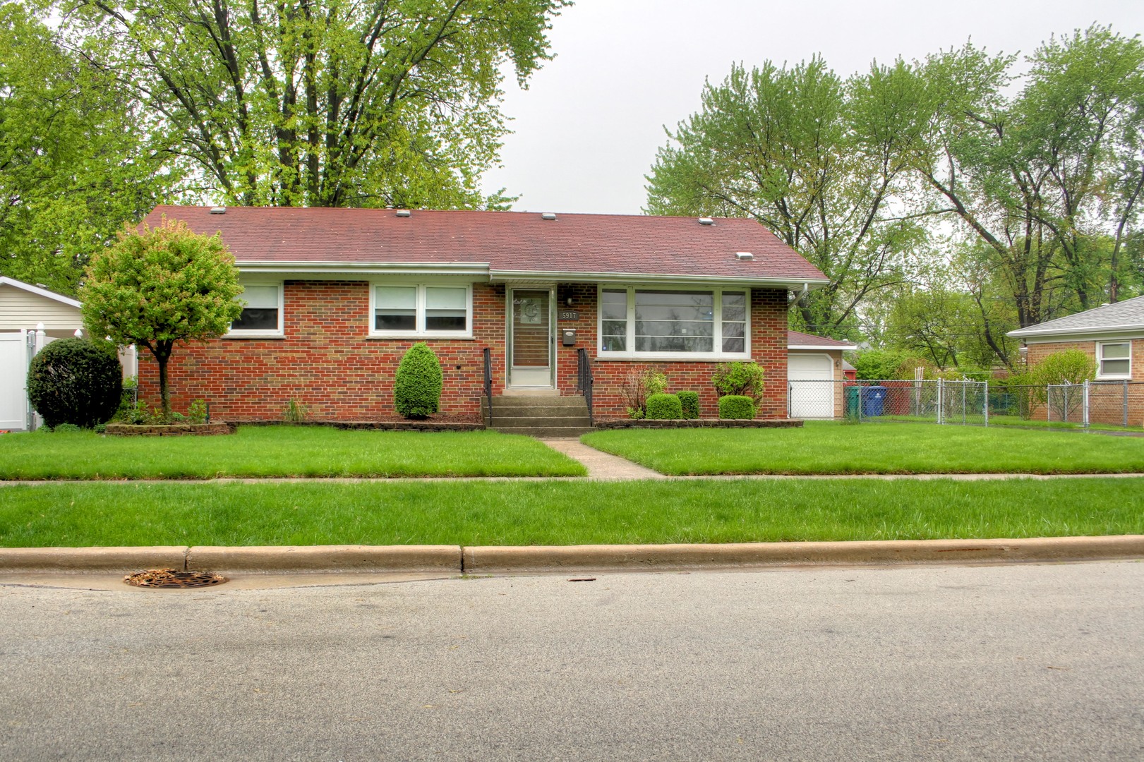 5917 108th Place Chicago Ridge, IL 60415 - Photo 1 of 34 a front view of a house with a garden