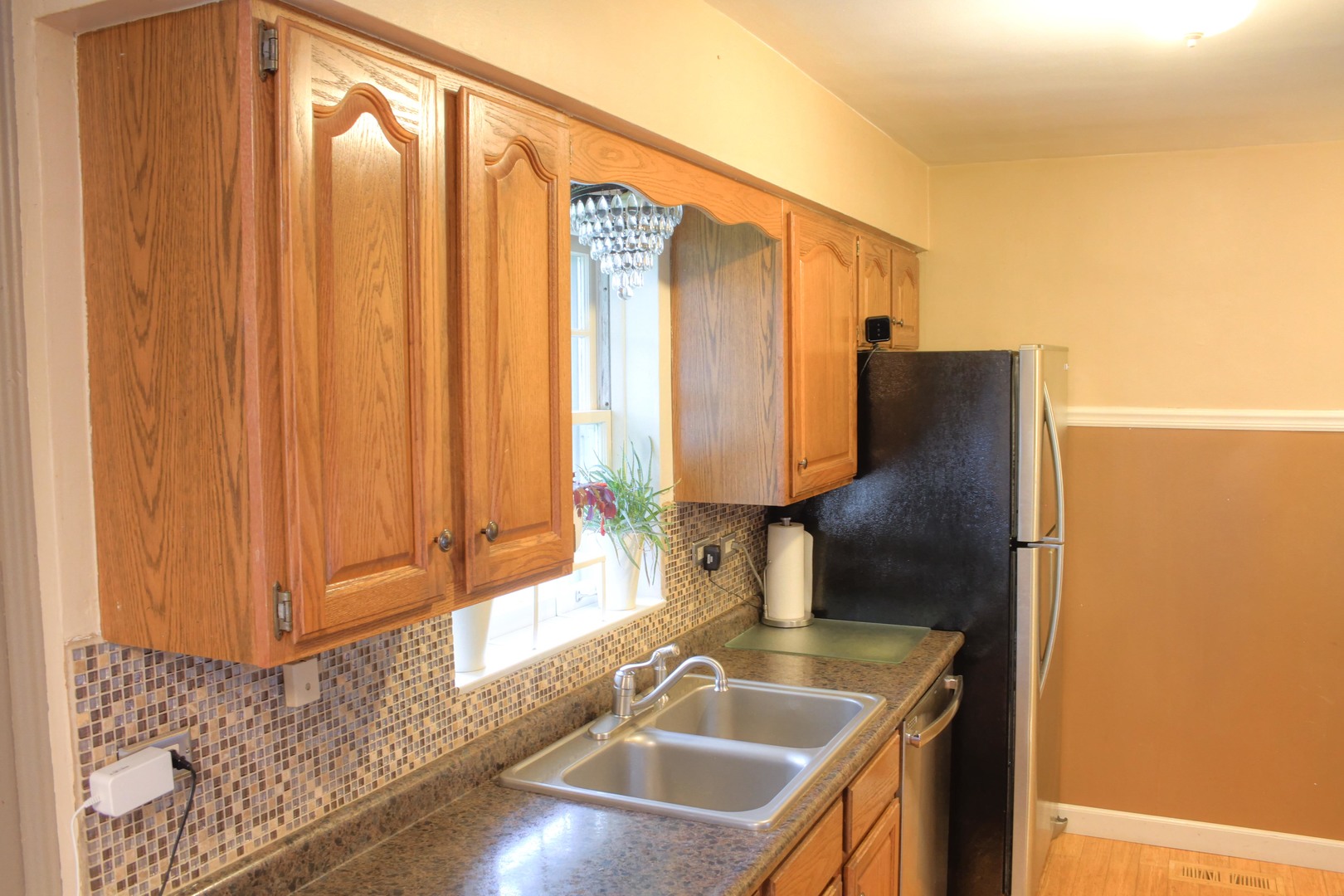 5917 108th Place Chicago Ridge, IL 60415 - Photo 13 of 34 a kitchen with a sink a counter top space and cabinets