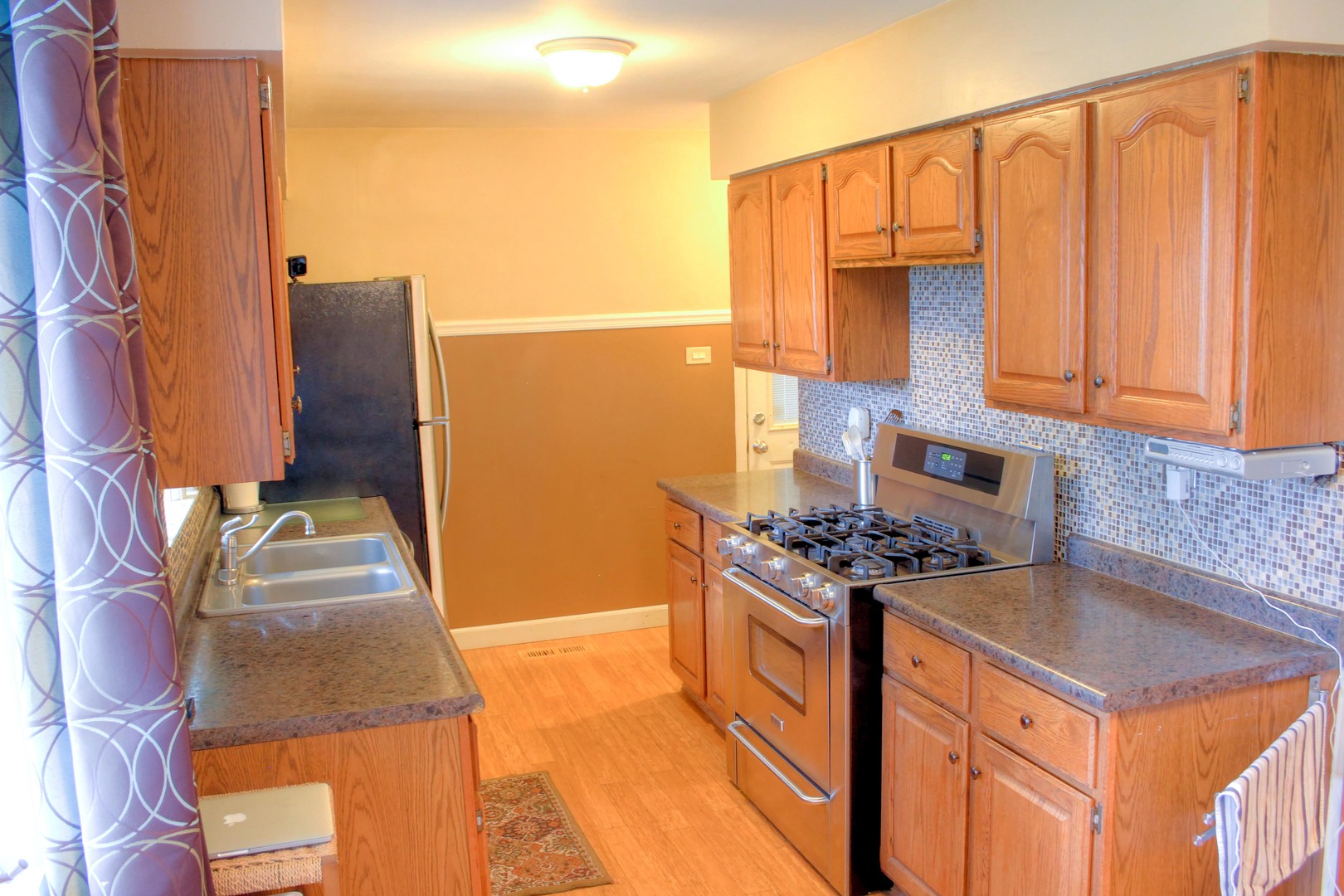 5917 108th Place Chicago Ridge, IL 60415 - Photo 14 of 34 a kitchen with stainless steel appliances granite countertop a stove a sink and a microwave