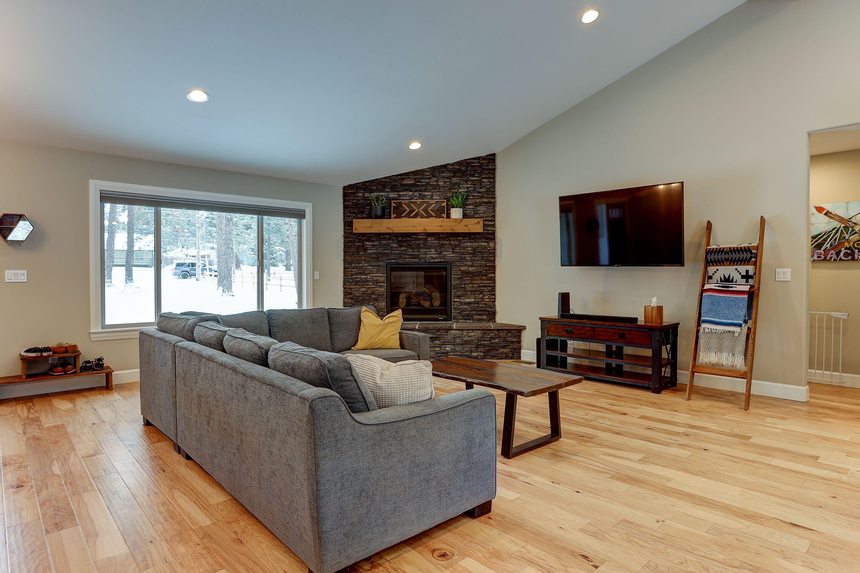19047 Pumice Butte Road Bend, OR 97702 - Photo 16 of 38 a living room with fireplace furniture and a flat screen tv