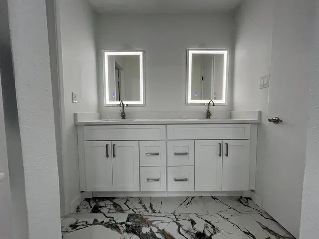 a white bath tub sitting next to a white toilet and a sink