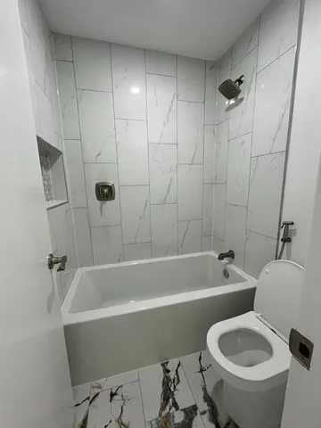 a view of walk in closet with wooden floor