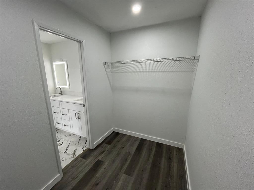 1105 Cherokee Trail Plano, TX 75023 - Photo 18 of 28 a view of walk in closet with wooden floor