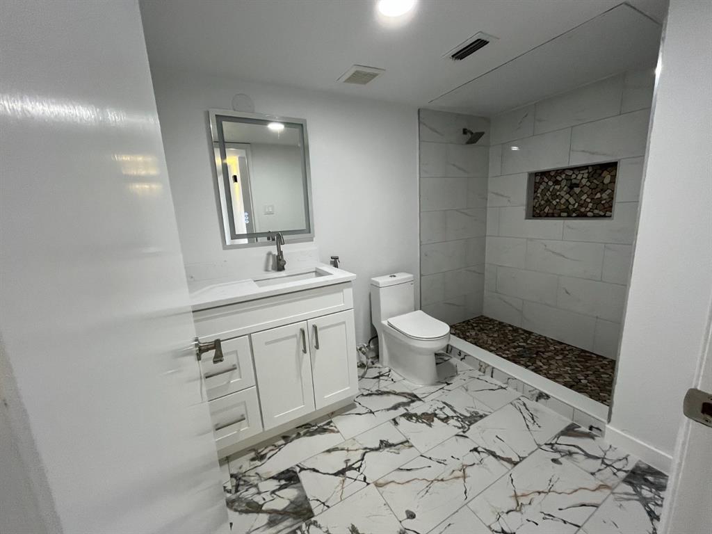 1105 Cherokee Trail Plano, TX 75023 - Photo 23 of 28 a bathroom with a sink toilet and mirror
